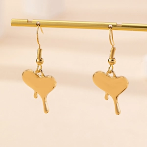 Golden heart-shaped drop earrings with liquid melting effect on a golden stand