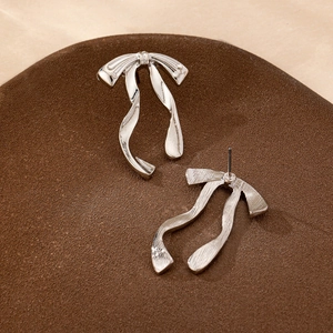 Elegant silver ribbon bow stud earrings with a brushed metallic finish for women
