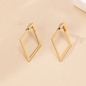 Detailed view of hollow geometric rhombus stud earrings in polished gold plating