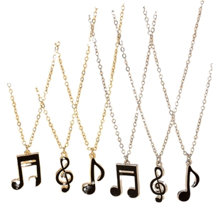 Fashionable musical note pendant necklace set in gold and silver finish with black enamel
