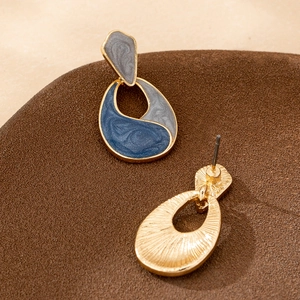 Fashionable gold drop earrings with blue and grey marble enamel in a geometric design