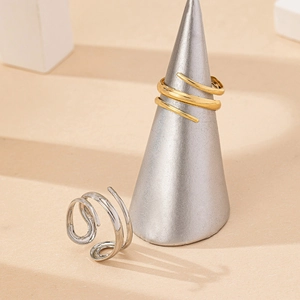 Minimalist gold and silver layered spiral wrap rings with polished metallic finish