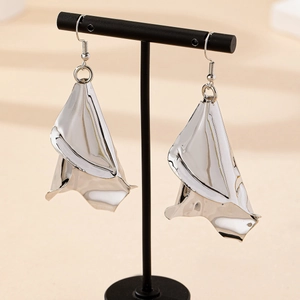 Elegant irregular hammered silver petal earrings displayed on a black jewelry stand