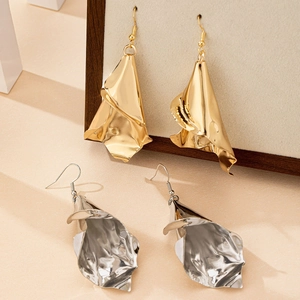 Modern irregular hammered metal drop earrings in gold and silver with elegant drape