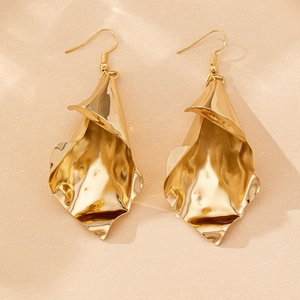 Detail of gold hammered drop earrings with vintage petal texture and hook design