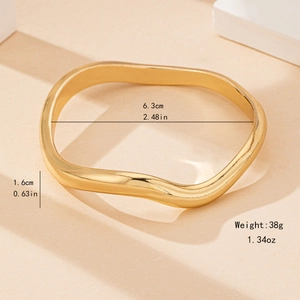 Polished gold irregular wavy bangle bracelet with product dimensions and weights shown