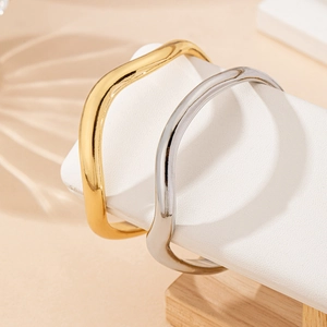 Minimalist irregular wave open cuff bracelets in polished gold and silver metal finishes