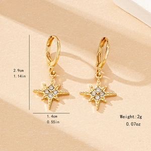 Elegant gold-tone starburst drop earrings featuring clear crystals and star pattern
