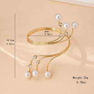 Elegant gold spiral arm cuff featuring multiple pearls and rhinestones on multi-layer wires