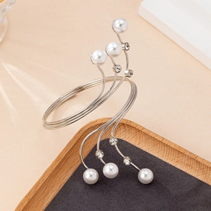 Silver multi-layer cuff bracelet with pearls and rhinestones on a wooden tray display