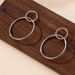 Minimalist silver geometric double-hoop earrings featuring textured and smooth metal rings