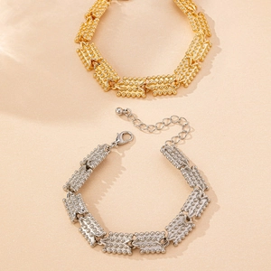 Detail of gold and silver textured link bracelets with lobster clasp and extension chain