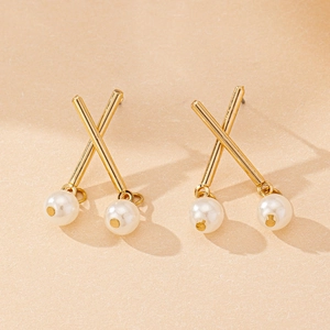 Detail view of gold-plated X-shape stud earrings with hanging double white pearls