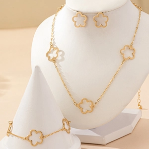 Elegant gold hollowed clover jewelry set including necklace, earrings and bracelet