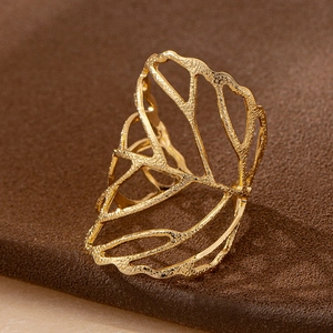 Golden leaf skeleton open ring with handmade hammered texture on dark background