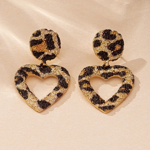 Detailed view of leopard print heart earrings with matte texture and vintage aesthetic