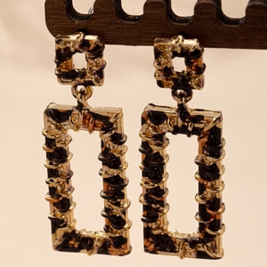 Vintage gold wire wrapped geometric black rectangle drop earrings on wood display stand