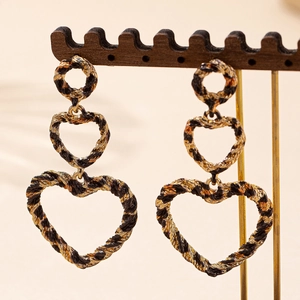 Boucles d'oreilles cœur à trois couches avec motif léopard sur un support à bijoux chic