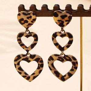 Three-tier hollow heart earrings with leopard print pattern on a wooden jewelry stand