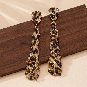 Elegant gold and black teardrop earrings with textured leopard pattern in vintage style