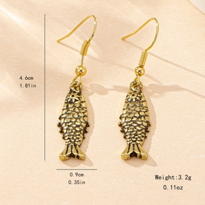 Vintage gold fish earrings with detailed scales and dimensions of 4.6cm by 0.9cm