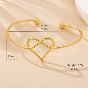Minimalist gold open cuff bracelet featuring an infinity heart knot design and dimensions