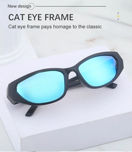 Detail of Y2K cat eye sunglasses with blue mirrored lenses on a white display block