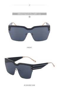 Vue de face et de profil de lunettes de soleil oversize demi-cerclées avec monture noire et verres gris