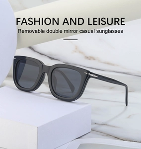 Detail of magnetic clip-on sunglasses with glossy black frame and silver arrow accents