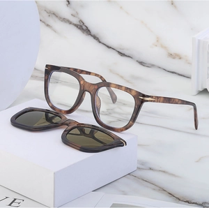 Detail of square tortoiseshell glasses frame with magnetic sunglasses clip-on attachment