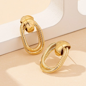 Elegant gold geometric hollow earrings with twisted rope texture in a minimalist retro design