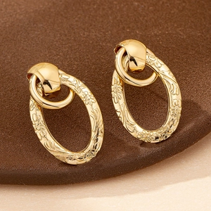 Elegant gold-plated oval earrings with intricate floral texture and double loop design