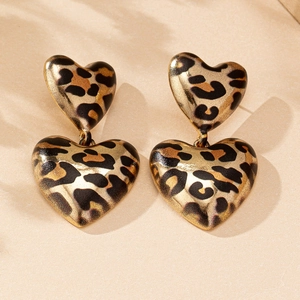 Close-up of leopard print heart earrings showing retro texture and golden metal links