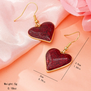 Romantic gold heart earrings with red glitter finish and 3.9cm hanging drop length