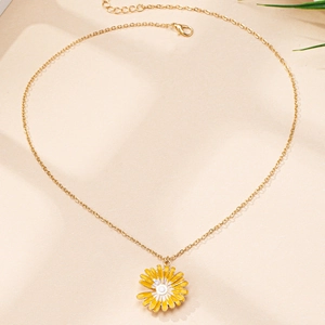 Detailed close-up of a yellow enamel daisy pendant necklace with a gold chain