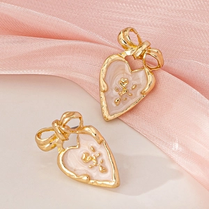 Pink marble enamel heart stud earrings with golden bow detail for women's fashion