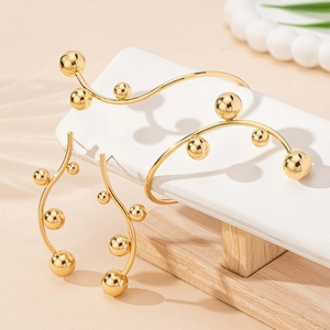 Elegant gold bead jewelry set with minimalist wavy ear cuffs and matching bracelet
