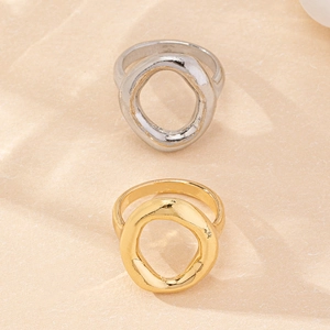Macro shot of minimalist hollow circular rings in polished gold and silver finishes
