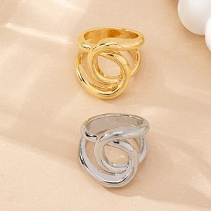 Detailed view of intertwined gold and silver rings with a polished minimalist finish