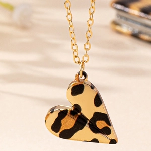 Elegant gold heart pendant necklace with leopard print pattern on a thin cable chain
