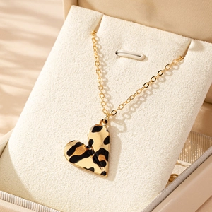 Fashionable leopard print heart pendant necklace on golden chain in beige jewelry box