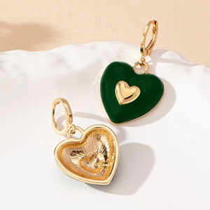 Golden heart earrings with dark green enamel and lever-back hoops for a romantic look