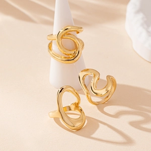 Three minimalist gold-plated irregular geometric rings with abstract wavy lines