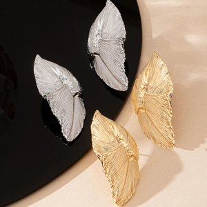 Elegant gold and silver leaf stud earrings with realistic vein texture on a sleek display