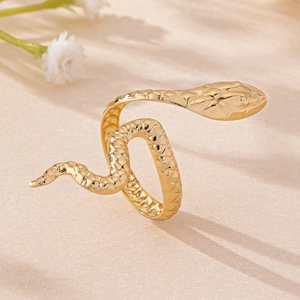 Elegant gold snake ring with realistic scale texture shown on a textured background