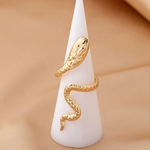 Close-up of golden snake ring with detailed scale texture on a white display stand