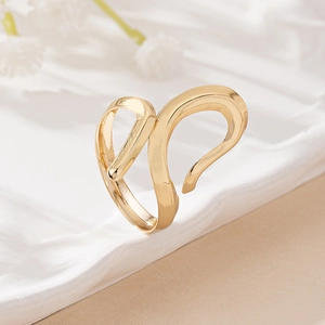 Elegant gold minimalist irregular open ring with abstract fluid lines on white fabric