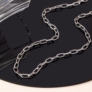 Close-up of silver paperclip chain necklace with sleek metallic finish and minimalist links