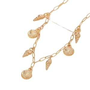 Golden shell necklace with scallop and spiral pendants on white background for beach style
