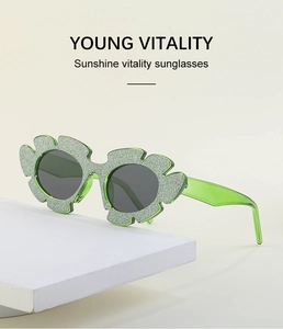 Close-up of glittery flower-shaped sunglasses with dark lenses and green temples